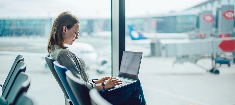 Person in an airport on a laptop